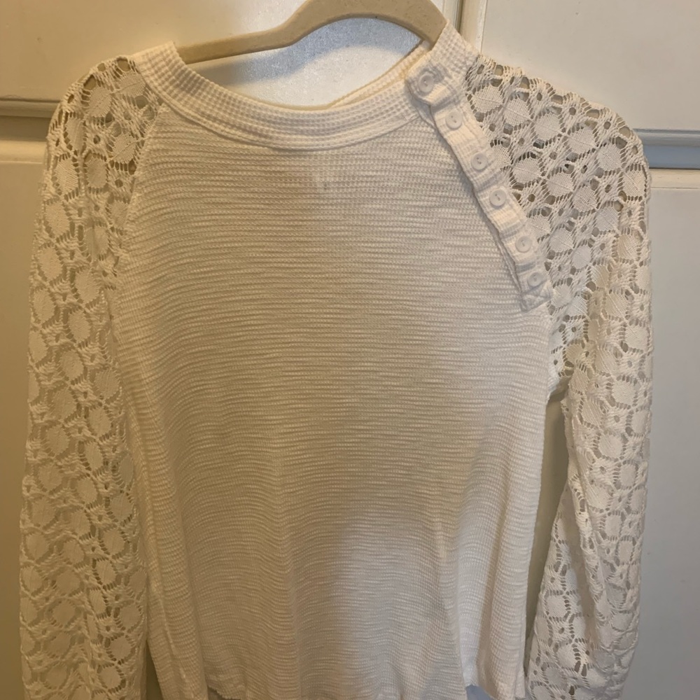 White blouse with button detail and detailed sleeves